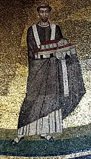 El papa Honorio I (fallecido en 638) sosteniendo un modelo de la iglesia que mandó construir. Mosaico de la Basílica de Santa Inés Extramuros de Roma