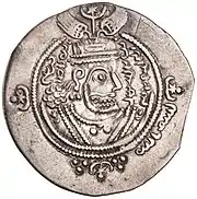 Coin with protruded inscription in Arabic and a crowned head seen side-on