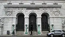 Photograph of the Chambers Street entrance showing three double-height arched doorways